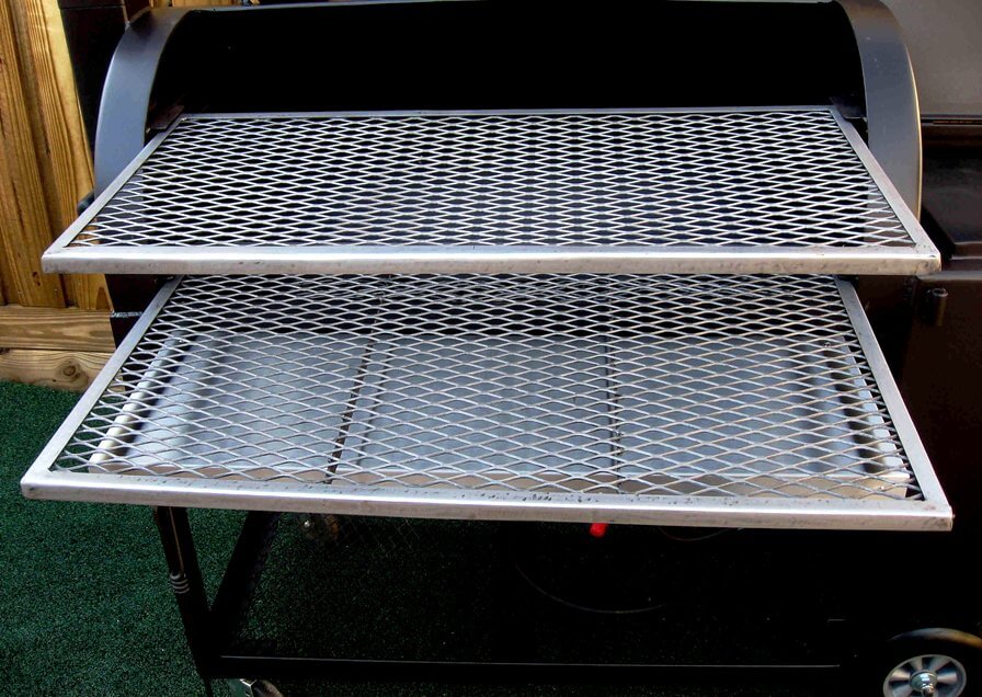 two slide out cooking grates which are fully supported in model 2442 smoker pit barrel